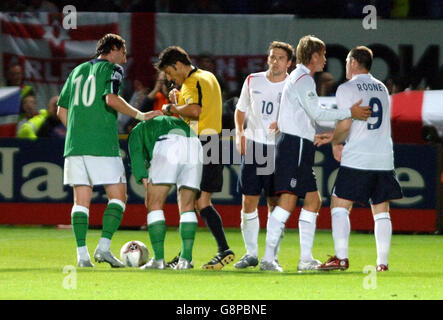 England captain David Beckham attempts to console Wayne Rooney (R) after he is shown the yellow card for a challenge on Northern Ireland's Keith Gillespie during the World Cup qualifier against at Windsor Park, Belfast, Wednesday September 7, 2005. PRESS ASSOCIATION Photo. Photo credit should read: Sean Dempsey/PA. Stock Photo