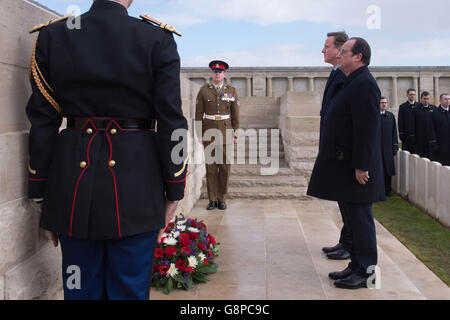 Prime Minister David Cameron and French President Francois Hollande after laying wreaths during a visit to Poizeres Cemetery near the town of Amiens, France, ahead of an Anglo-French Summit hosted by President Hollande. Stock Photo