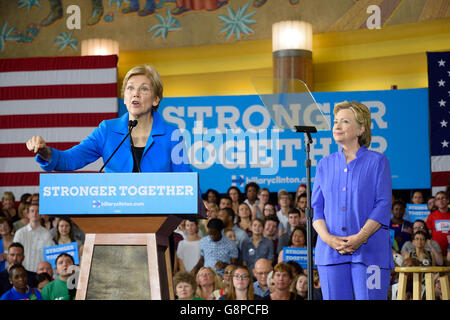 U.S. Senator Elizabeth Warren speaks as U.S. Democratic Presidential candidate Hillary Clinton looks on.