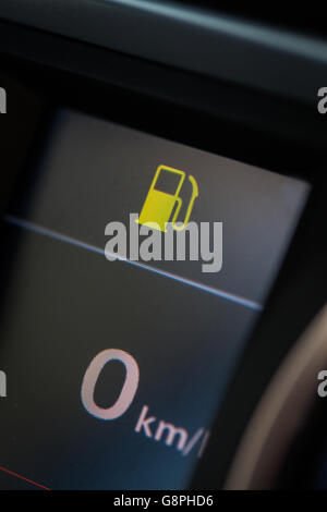 Close up shot of a car's dashboard with the fuel icon lit. Stock Photo