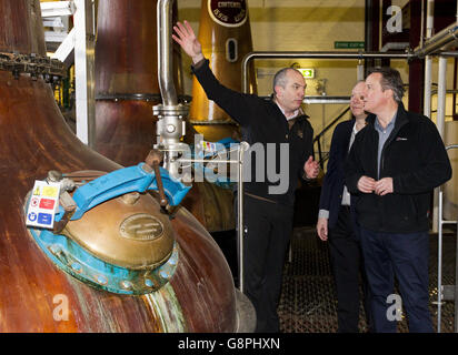 Prime Minister David Cameron shown the whiskey stills of Bushmills Distillery by manager Colum Egan (left) and Chairman David Gosnell during his visit to Bushmills distillery in Co Antrim as he continues a tour of the UK setting out the case for staying in the European Union.