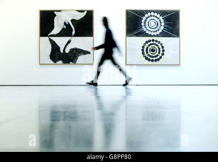 A man walks past 'Group IX: The Swan, 1914' by Swedish artist Hilma af Klint during the press preview of 'Hilma af Klint: Painting the Unseen' exhibition at the Serpentine Gallery, London. Stock Photo