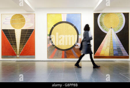 A woman views 'Altarpiece no.2, no.3 and no.1' 1915 by Swedish artist Hilma af Klint during the press preview of 'Hilma af Klint: Painting the Unseen' exhibition at the Serpentine Gallery, London. Stock Photo