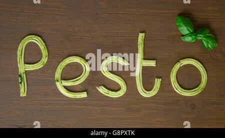 Word pesto made of cooked spaghetti with pesto souce Stock Photo