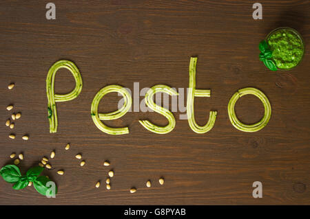 Word pesto made of cooked spaghetti with pesto souce Stock Photo