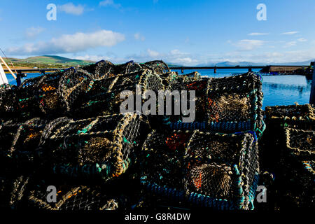 Lobster, cray and crab pots stacked up on the pier in Portmagee in County Kerry Ireland, Europe. Stock Photo