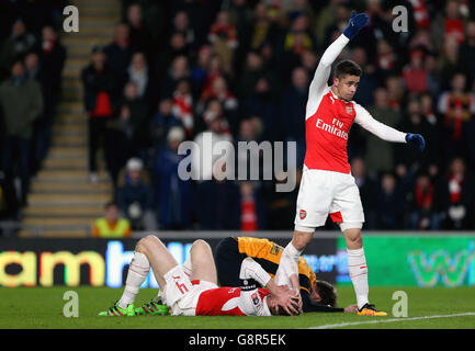 Arsenal's Gabriel Paulista reacts as Arsenal's Per Mertesacker (floor) collides with Hull City's Nick Powell Stock Photo
