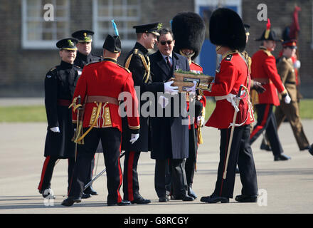 The Duke of Cambridge (centre) prepares to present sprigs of shamrock to the Irish Guards as he visits Cavalry Barracks in Hounslow, west London, for the regiment's St Patrick's Day Parade. Stock Photo