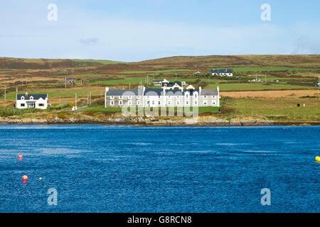 Houses on the shoreline of Valentia Island opposite the harbour of Portmagee in County Kerry Ireland, Europe. Stock Photo
