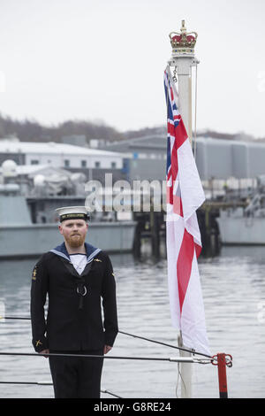 A submariner during a commissioning ceremony at Faslane naval base on the Clyde where the 7,400-tonne nuclear-powered submarine officially joined the Royal Navy fleet. Stock Photo