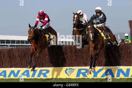 Village Vic ridden by Richard Johnson (right) and Road To Riches ridden by Bryan Cooper (left) jump the fence during the Ryanair Chase during St Patrick's Thursday of the 2016 Cheltenham Festival at Cheltenham Racecourse. PRESS ASSOCIATION Photo. Picture date: Thursday March 17, 2016. See PA story RACING Cheltenham. Photo credit should read: David Davies/PA Wire. Stock Photo