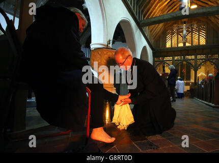 The Archbishop of Canterbury Justin Welby performs a foot washing ritual for members of the congregation during the Maundy Thursday service at St. Dunstan's Church in Frinsted, Kent. Stock Photo