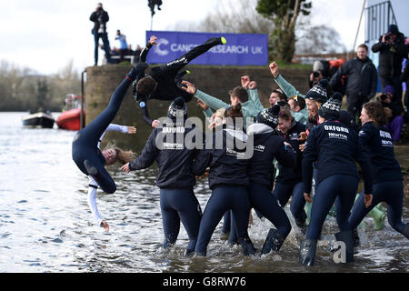 Cambridge Men's Blue Boat cox Ian Middleton (second left) and Oxford Women's Blue Boat cox Rosemary Ostfeld (left) are thrown into the river Thames as the two crews celebrate their victories in the respective Boat Races on the River Thames, London. Stock Photo