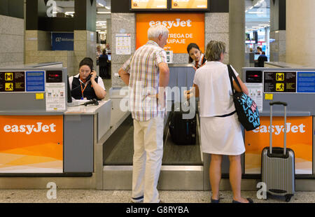 Airport luggage check in; Passengers at the Easyjet baggage drop, Palma airport, Mallorca ( Majorca ), Balearic Islands, Spain Europe Stock Photo