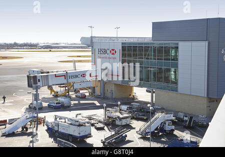 Air bridge access at Terminal 3 of London's Heathrow Airport. Shows service vehicles awaiting the arrival of the next plane Stock Photo