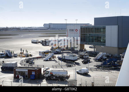 Air bridge access at Terminal 3 of London's Heathrow Airport. Shows service vehicles awaiting the arrival of the next plane Stock Photo