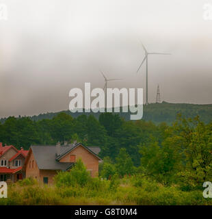 windmill on mountain in thick summer fog Stock Photo
