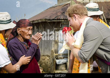 Prince Harry excahnges a namaste with 86-year-old Mrs Pakuli Gurung at Bhir Kuna as the Prince visits the earthquake struck village in Nepal and sees its reconstruction. Stock Photo