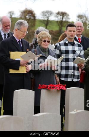 Musician Harry Judd (right) with his father Christopher (left) aunt Selina Cohen (middle) attends the rededication ceremony of his great great uncle The Reverend Alan Judd MC at the Fifteen Ravine British Cemetery in Villers-Plouich, France. Stock Photo