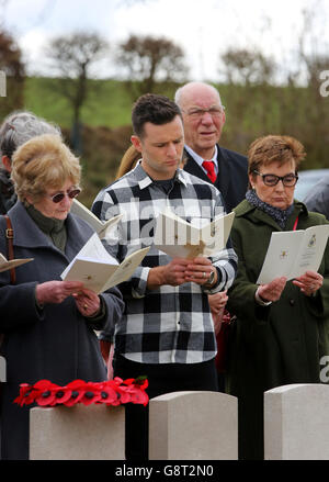 Musician Harry Judd (middle) attends the rededication ceremony of his great great uncle The Reverend Alan Judd MC at the Fifteen Ravine British Cemetery in Villers-Plouich, France. Stock Photo