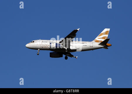 Plane Stock - Heathrow Airport. A British Airways Airbus A319-131) plane with the registration G-EUPA lands at Heathrow Stock Photo
