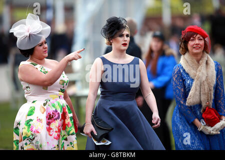 Female racegoers during Ladies Day of the Crabbie's Grand National Festival at Aintree Racecourse, Liverpool. Stock Photo