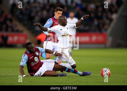 Swansea City's Modou Barrow is challenged by Aston Villa's Aly Cissokho during the Barclays Premier League match at the Liberty Stadium, Swansea. Stock Photo