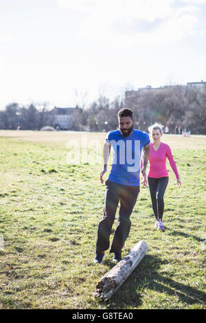 Young couple exercising in city park Stock Photo
