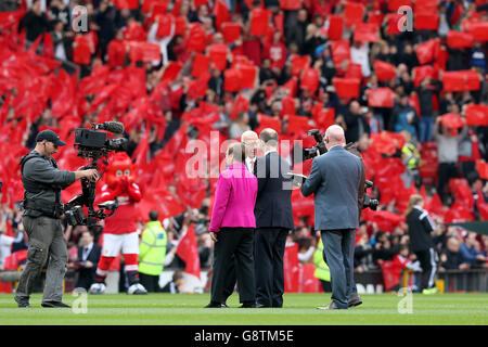 Sir Bobby Charlton (centre) on the pitch with his wife Norma Ball as the South Stand is officially renamed the Sir Bobby Charlton Stand, before the Barclays Premier League match at Old Trafford, Manchester. PRESS ASSOCIATION Photo. Picture date: Sunday April 3, 2016. See PA story SOCCER Man Utd. Photo credit should read: Martin Rickett/PA Wire. Stock Photo