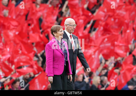 Sir Bobby Charlton on the pitch with his wife Norma Ball as the South Stand is officially renamed the Sir Bobby Charlton Stand, before the Barclays Premier League match at Old Trafford, Manchester. Stock Photo