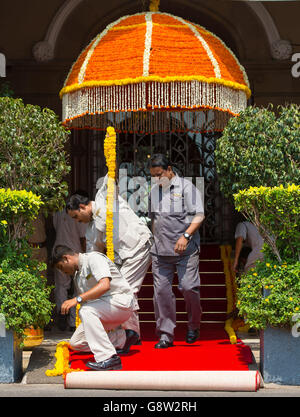 Workers prepare a red carpet for the arrival of the Duke and Duchess of Cambridge at the Taj Mahal Palace hotel in Mumbai, India, on day one of the royal tour to India and Bhutan. Stock Photo
