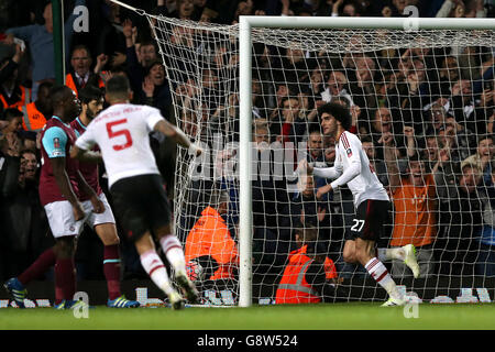 Manchester United's Marouane Fellaini (right) celebrates scoring their second goal of the game during the Emirates FA Cup, Quarter Final Replay match at Upton Park, London.