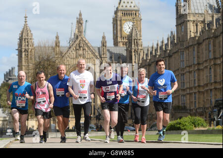 Members of Parliament (from left) Alistair Burt, Alun Cairns, Simon Danczuk, Graham Evans, Dan Jarvis, Jamie Reed, Amanda Solloway and Edward Timpson, outside the Houses of Parliament in central London as they prepare to run in this year's Virgin Money London Marathon. Stock Photo