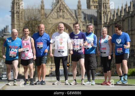 Members of Parliament (from left) Alistair Burt, Alun Cairns, Simon Danczuk, Graham Evans, Dan Jarvis, Jamie Reed, Amanda Solloway and Edward Timpson, outside the Houses of Parliament in central London as they prepare to run in this year's Virgin Money London Marathon. Stock Photo