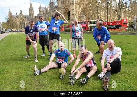 Members of Parliament (from left) Dan Jarvis, Jamie Reed, Edward Timpson, Alistair Burt, Amanda Solloway, Alun Cairns, Simon Danczuk and Graham Evans outside the Houses of Parliament in central London as they prepare to run in this year's Virgin Money London Marathon. Stock Photo