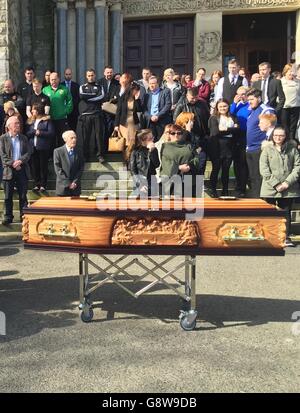 Family and friends attend the funeral of Michael McGibbon attend the Holy Cross church in Belfast for the funeral of taxi driver Michael McGibbon. Stock Photo