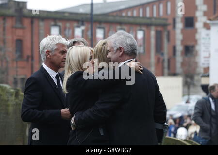 Holly Willoughby (left) hugs Eamonn Holmes (right) as Phillip Schofield hugs Ruth Langsford outside Sunderland Minster ahead of the funeral of TV agony aunt Denise Robertson. Stock Photo