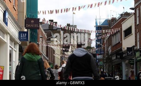 Bunting hangs in Windsor town centre in Berkshire in preparation for The Queen's 90th birthday. She will emerge from Windsor castle on April 21, her 90th birthday, to unveil a plaque for The Queen's Walkway, at the foot of Castle Hill. Stock Photo