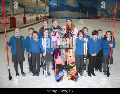 EDITORIAL USE ONLY Stacey Solomon (centre right), who took part in The Jump, and British Olympic snowboarder, Aimee Fuller (centre left), launch the inaugural National Schools Snowsport Week, with pupils from the Larmenier and Sacred Heart Catholic Primary School, at The Snow Centre in Hemel Hempstead, Hertfordshire. Stock Photo