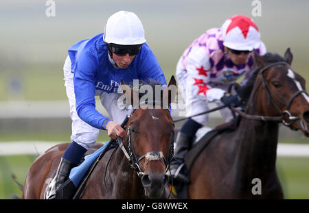 Linguistic ridden by William Buick (left) on his way to winning the 200,000 Tattersalls Millions 3-Y-O Trophy during day three of the Craven Meeting at Newmarket Racecourse. Stock Photo