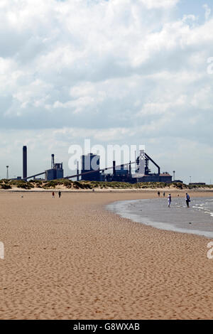 Wide  beach at Coatham Redcar and Cleveland, UK, in front of the Redcar steel works recently owned by Tata Steel.