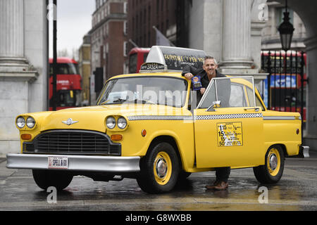 Gary Lineker by a yellow New York taxi as he brings Thailand, Morocco, India and New York to Marble Arch, London, for the launch of Walkers Spell & Go campaign, where people collect letters in packs of crisps to be in with a chance of winning one of 20,000 holidays up for grabs. Stock Photo