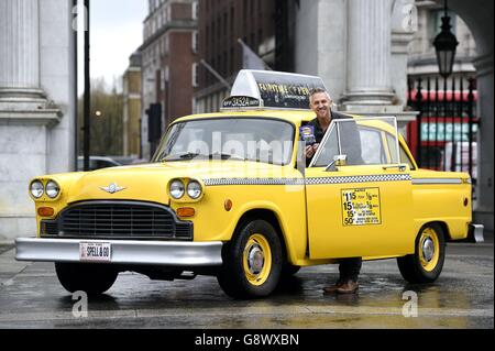 Gary Lineker by a yellow New York taxi as he brings Thailand, Morocco, India and New York to Marble Arch, London, for the launch of Walkers Spell & Go campaign, where people collect letters in packs of crisps to be in with a chance of winning one of 20,000 holidays up for grabs. Stock Photo