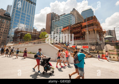 Tourists pass the entrance stairs to Liberty Park overlooking the 9/11 Memorial in New York on opening day Wednesday, June 29, 2016. The one-acre park. 25 feet above the ground, sits atop of the World Trade Center vehicle security center and abuts the under construction St. Nicholas Greek Orthodox Church which occupied the space before it was destroyed on 9/11. (© Richard B. Levine) Stock Photo