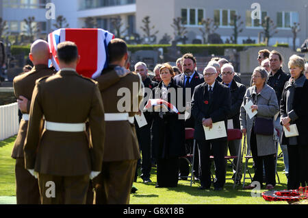 John Howdon, great nephew (middle) and Kathleen Grantham, great niece, (second from left) watch the coffin of their great uncle and First World War soldier Gunner Albert Venus arrive at Ypres Town Cemetery in Belgium for a funeral service for him and five other soldiers killed in action in 1915. Stock Photo