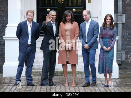 (Left to right) Prince Harry, President and First Lady of the United States Barack Obama and his wife Michelle, and the Duke and Duchess of Cambridge pose for a photo in Clock Court, at Kensington Palace, London, as they arrive ahead of a private dinner hosted by the Royal couple in their official residence at the palace. Stock Photo