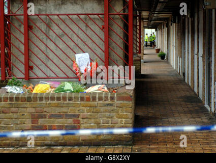 Floral tributes behind a police line on the Milford Towers estate in Catford, south London, Friday September 30, 2005, where the body of Rochelle Holness was found on Wednesday morning. A man and woman were today being questioned about the murder of the 15-year-old girl whose dismembered body was found inside binliners and dumped on open ground on the estate. Rochelle, who was from Lewisham, south London, had gone out to use a telephone box near the estate on Sunday night and was later reported missing. See PA story POLICE Girl. PRESS ASSOCIATION photo. Photo credit should read: Fiona