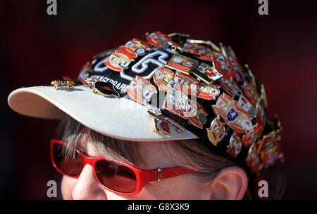 A Liverpool fan wearing a hat covered in pin badges during the Barclays Premier League match at Anfield, Liverpool. PRESS ASSOCIATION Photo. Picture date: Saturday April 23, 2016. See PA story SOCCER Liverpool. Photo credit should read: Nigel French/PA Wire. RESTRICTIONS: No use with unauthorised audio, video, data, fixture lists, club/league logos or 'live' services. Online in-match use limited to 75 images, no video emulation. No use in betting, games or single club/league/player publications. Stock Photo