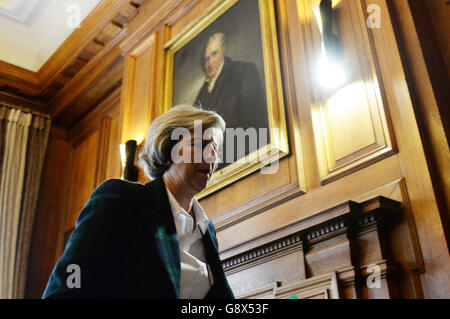 Home Secretary Theresa May leaves after delivering a speech on Great Britain, Europe and our place in the world under a portrait of George Stephenson, the first president of the Institute of Mechanical Engineers, at One Birdcage Walk in Westminster, London. Stock Photo