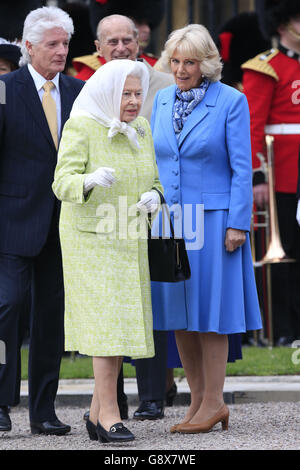 Queen Elizabeth II, accompanied by the Duchess of Cornwall, attends a beacon lighting event at the Cambridge Gate of Windsor Castle, as she celebrates her 90th birthday. Stock Photo